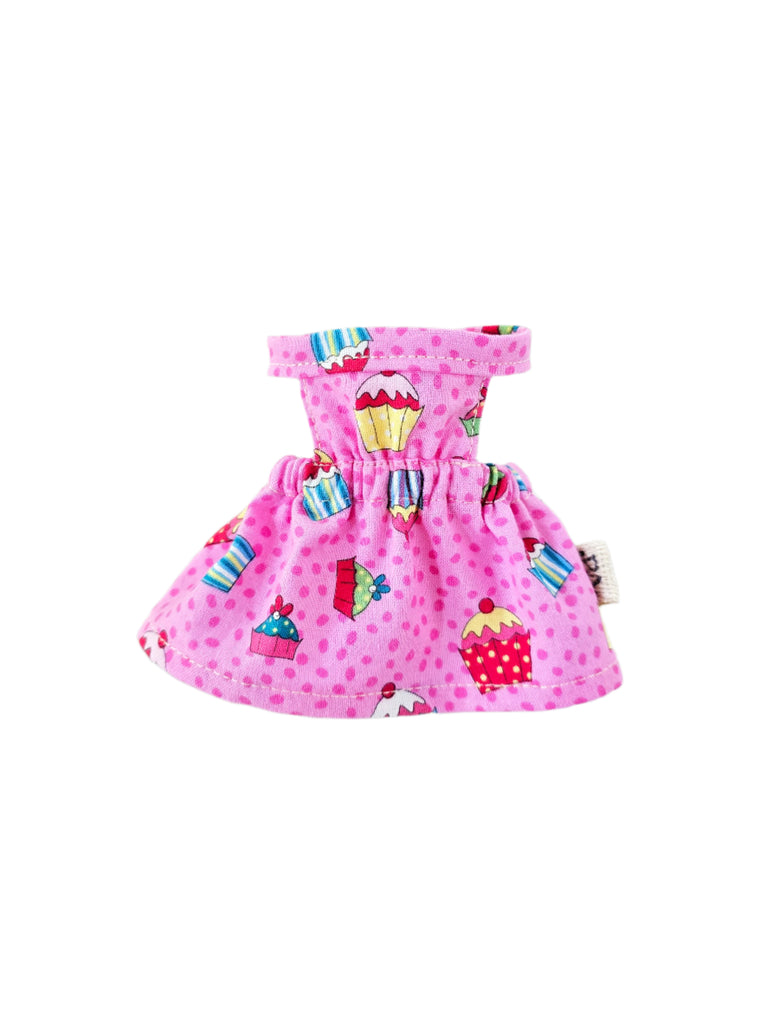 Pink dress with cupcake pattern on a white background