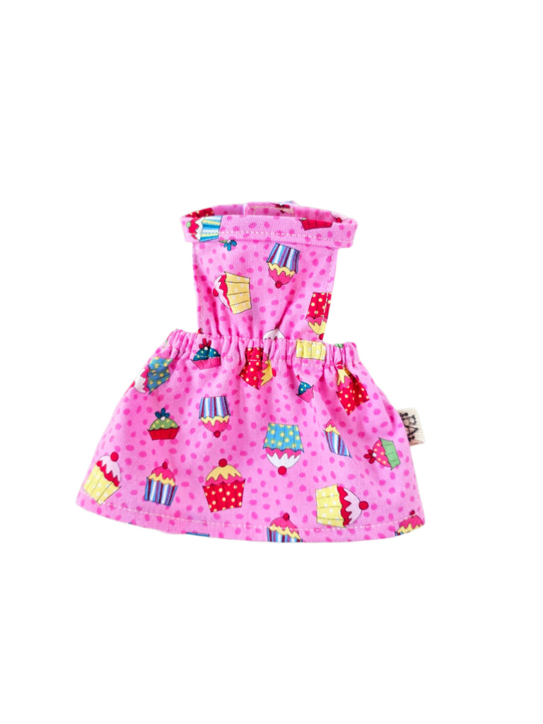 Pink dress with cupcake pattern on a gray background
